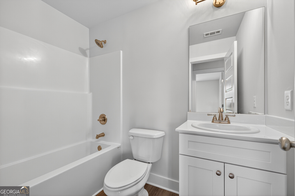 435 Watson Road Winder, GA 30680 - Photo 18 of 36 a bathroom with a sink a toilet and shower