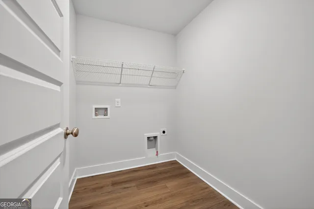 a kitchen with a sink stove and wooden floor