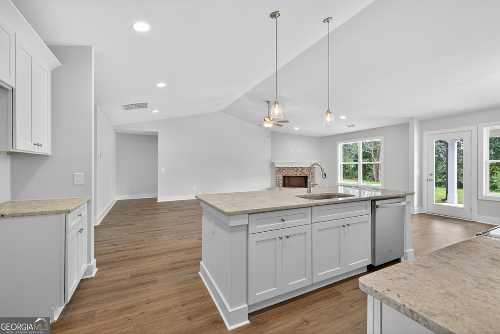 435 Watson Road Winder, GA 30680 - Photo 20 of 36 a kitchen with a sink stove and wooden floor