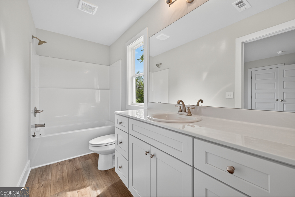 435 Watson Road Winder, GA 30680 - Photo 26 of 36 a bathroom with a granite countertop sink a toilet and shower