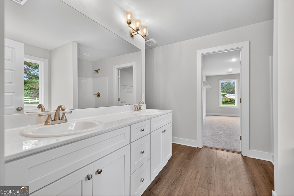 435 Watson Road Winder, GA 30680 - Photo 31 of 36 a bathroom with a double vanity sink and a mirror
