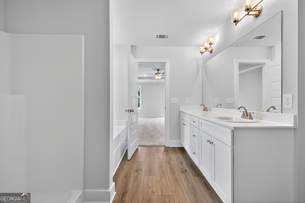435 Watson Road Winder, GA 30680 - Photo 33 of 36 a bathroom with a double vanity sink and mirror