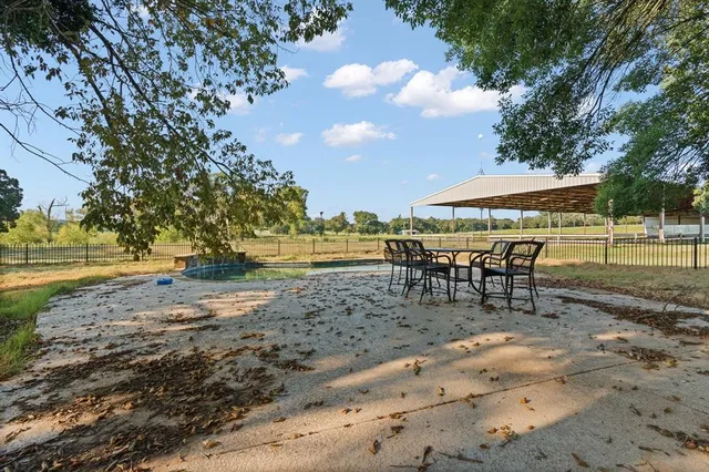 a view of a swimming pool with an outdoor seating