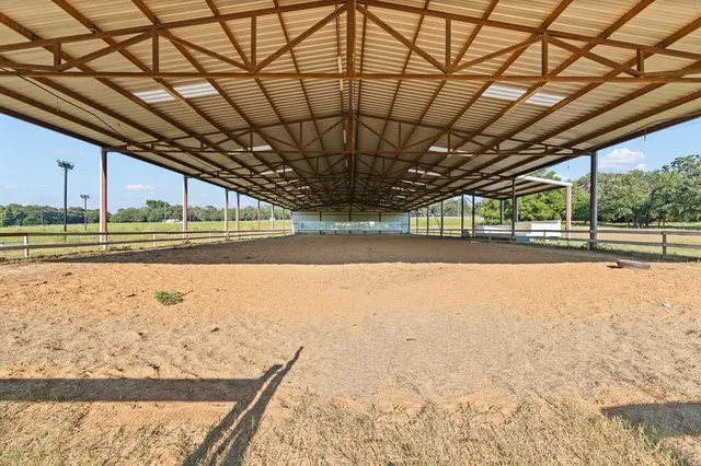 an aerial view of a house with a yard and lake view