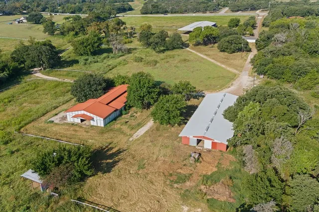 a front view of house with backyard and trees