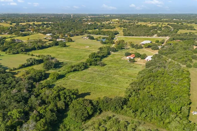 an aerial view of residential houses with outdoor space and swimming pool