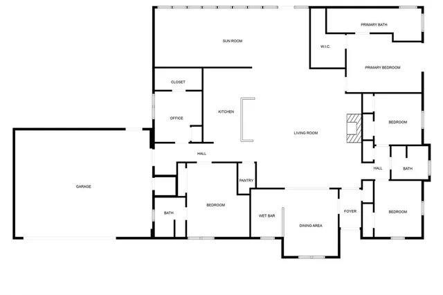 a view of an empty room with wooden floor and a kitchen