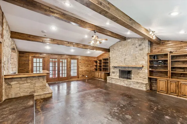 an empty room with wooden floor and fireplace
