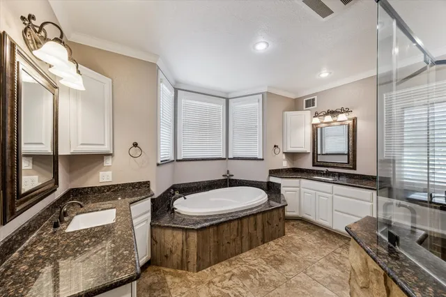 a spacious bathroom with a granite countertop sink and a mirror