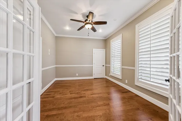 wooden floor in an empty room with a window