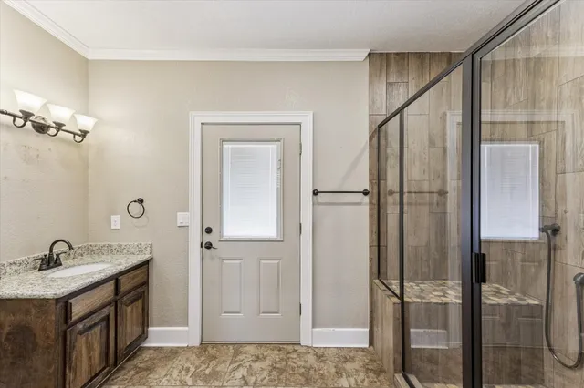 a bathroom with a shower sink and mirror