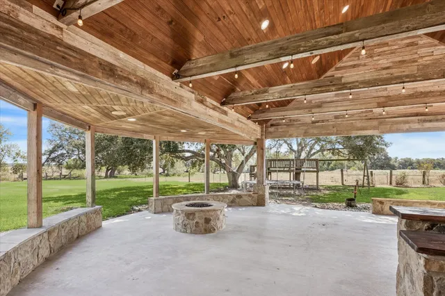 a view of a backyard with porch and garden