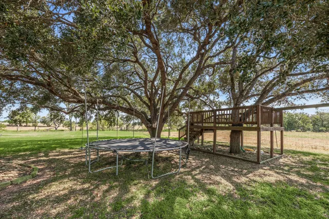 a big yard with lots of green space and trees