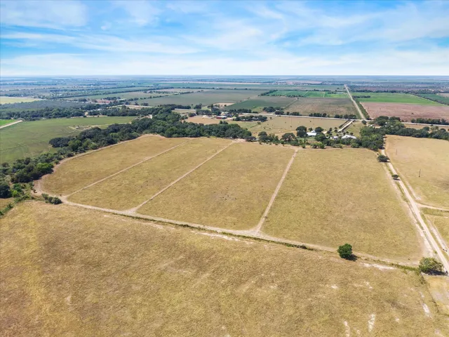 an aerial view of beach and residential houses with outdoor space