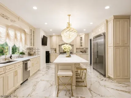 a large kitchen with kitchen island granite countertop a counter top space appliances and cabinets
