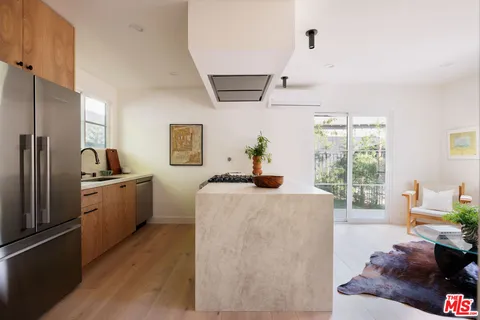 a living room with furniture and a kitchen