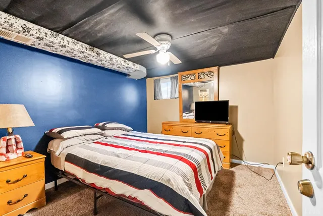 a bed sitting in a bedroom next to a window