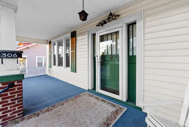 a backyard of a house with lots of green space and fountain