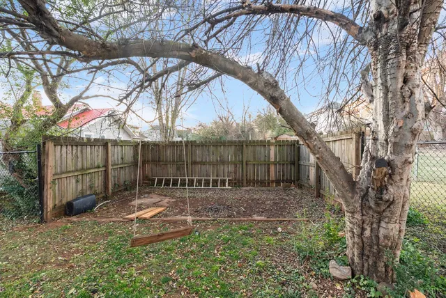 a front view of a house with a yard and sitting area