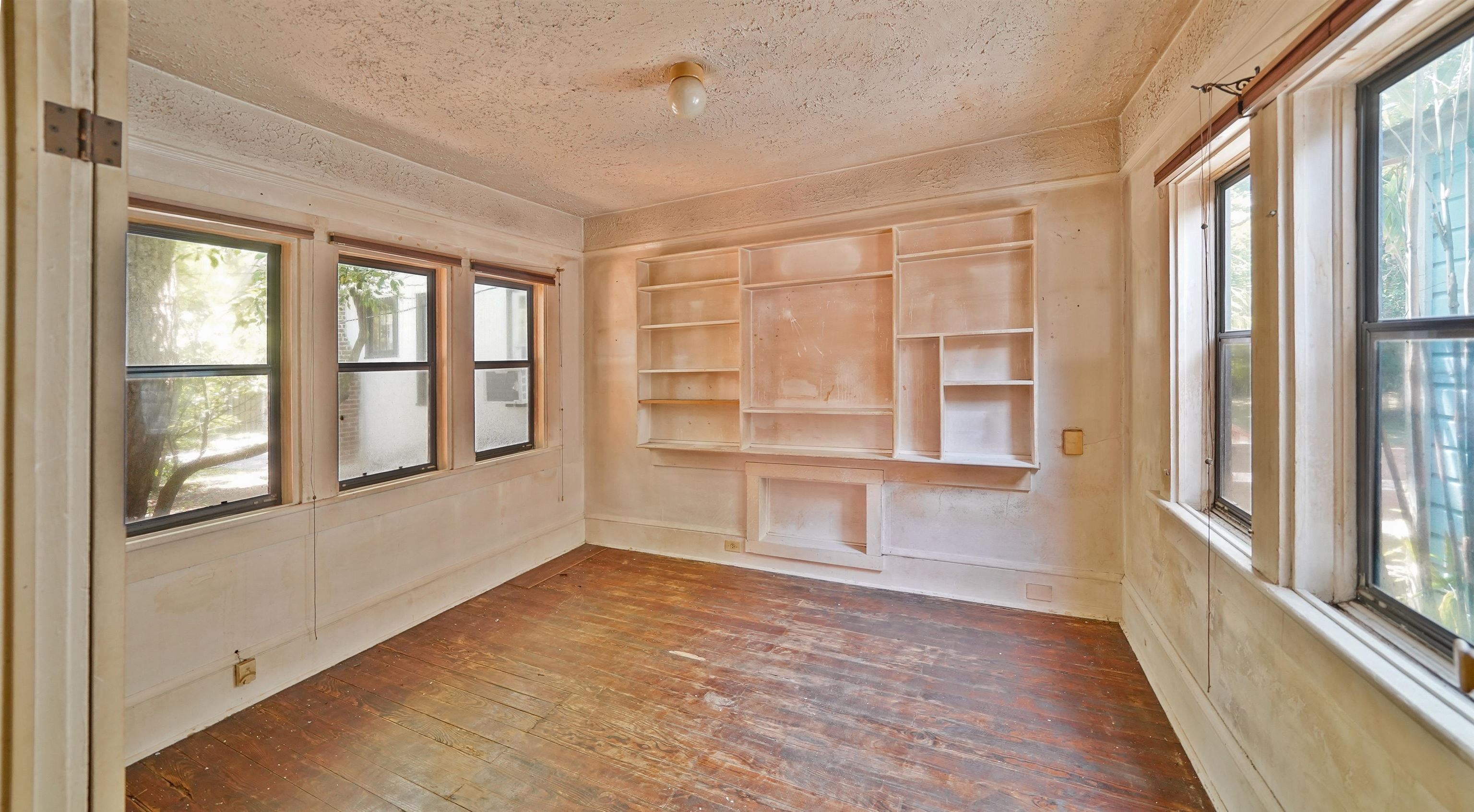 136 Washington Street St. Augustine, FL 32084 - Photo 7 of 15 a view of an empty room with a window and wooden floor