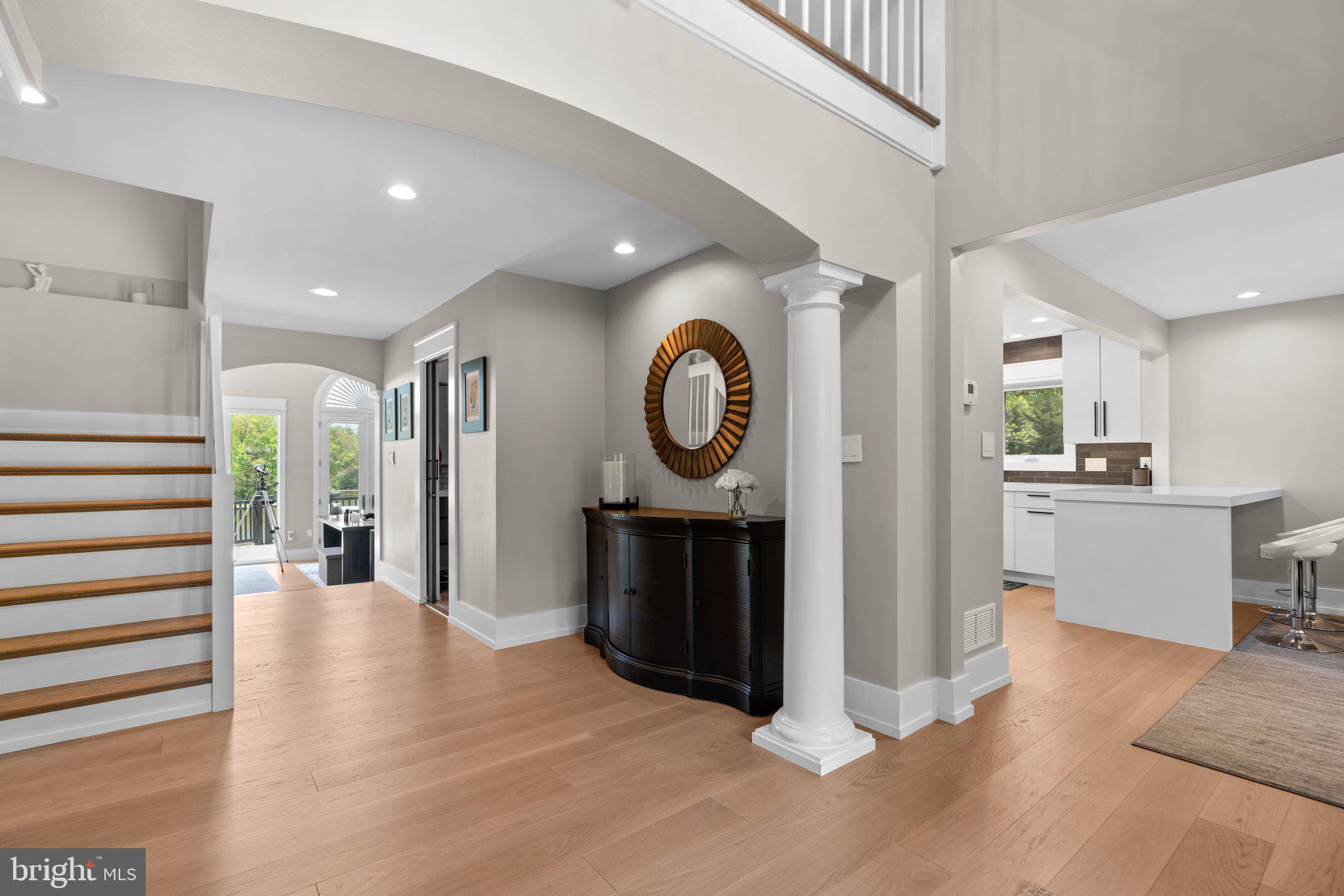 910 Lynch Drive Arnold, MD 21012 - Photo 7 of 67 a view of a hallway with wooden floor and a fireplace