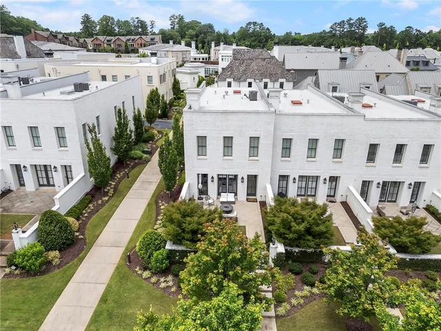 a view of a white building among the yard and deck