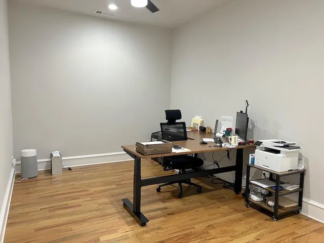 a workspace with furniture and wooden floor