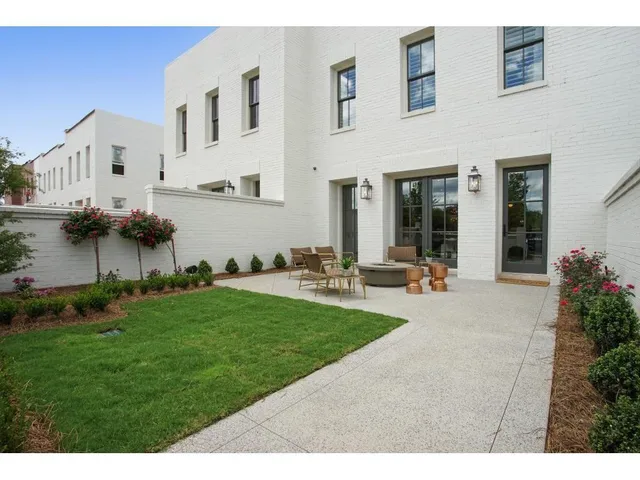 a view of a house with backyard and sitting area