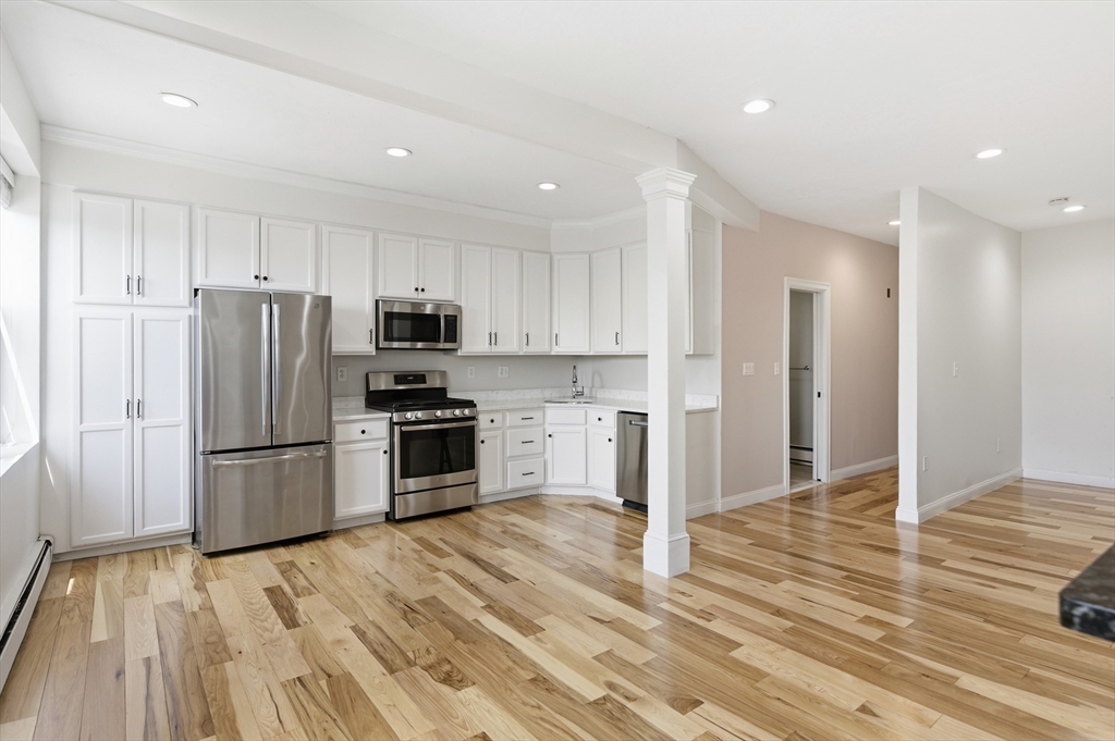 54 Beacon Street, Unit 2 Chelsea, MA 02150 - Photo 9 of 26 a kitchen with stainless steel appliances a refrigerator and a stove top oven