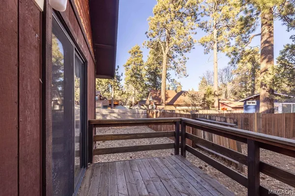 a view of balcony with wooden floor and fence