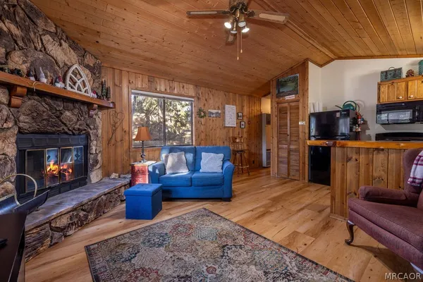 a living room with furniture a fireplace and a flat screen tv