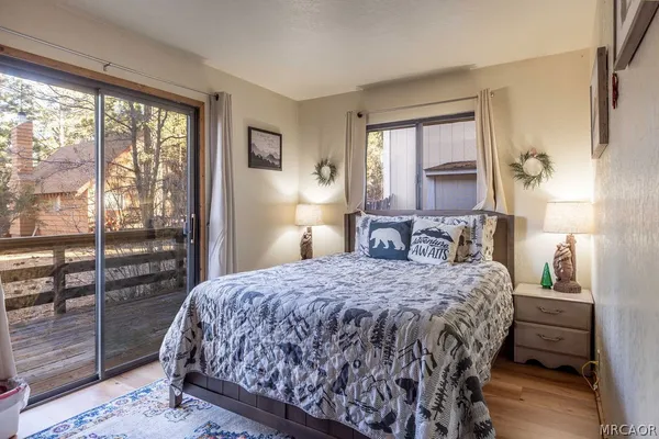 a bedroom with a large bed and a wooden floor