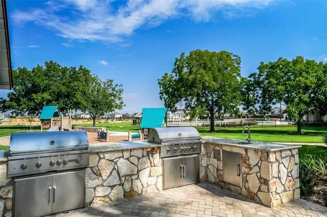 a view of a kitchen with stainless steel appliances and stove top oven