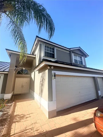 a front view of a house with parking space