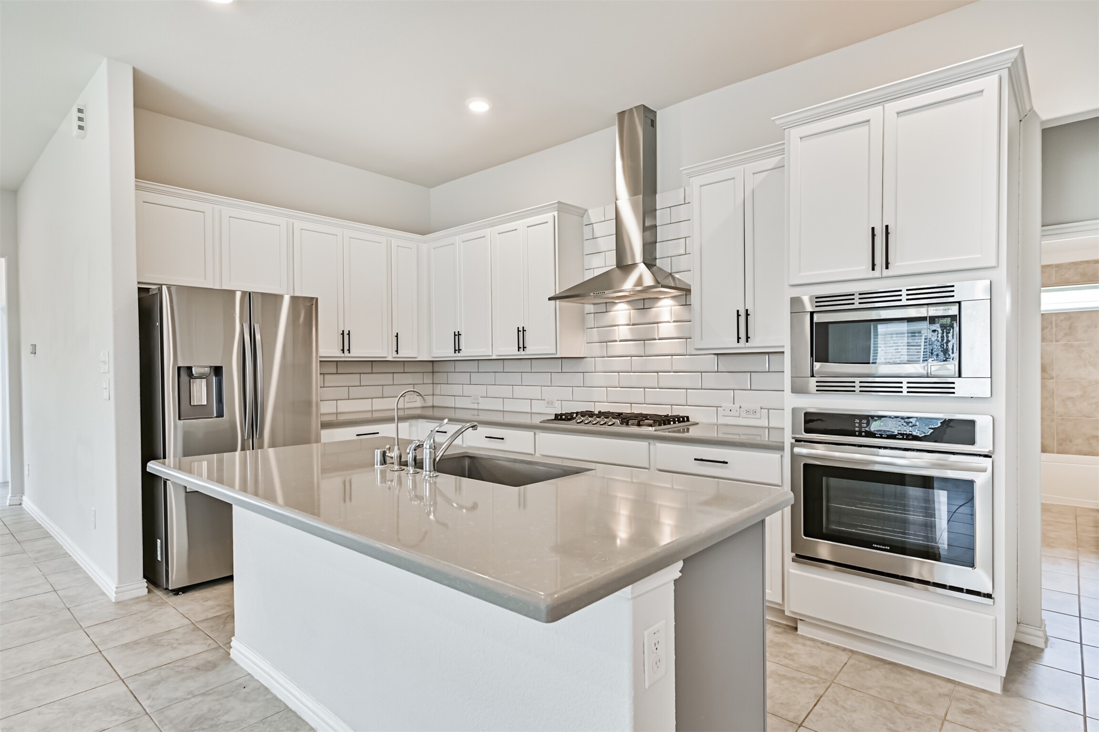 7019 Terra Drive Manvel, TX 77578 - Photo 20 of 41 a kitchen with stainless steel appliances granite countertop a sink stove and refrigerator