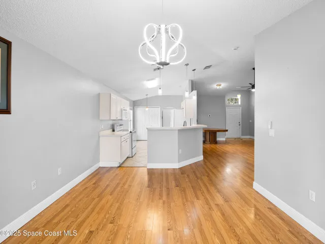 a view of a kitchen with wooden floor