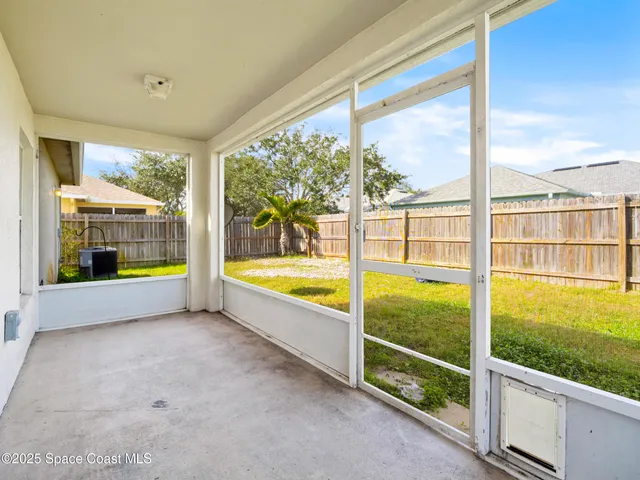 a view of an empty room with a large window