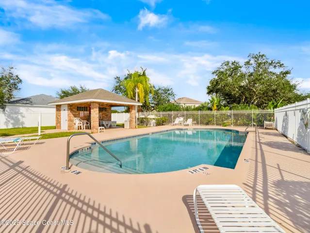 a view of a swimming pool with a lounge chairs