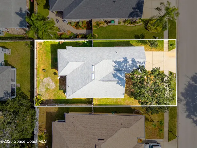 an aerial view of a house with a yard