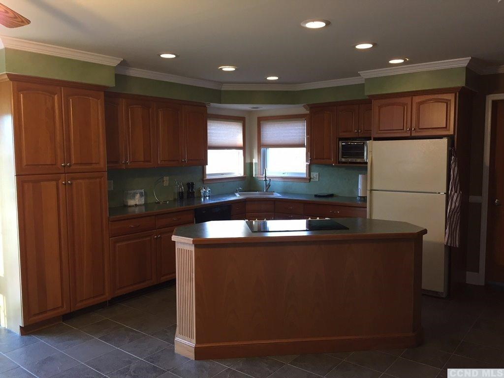 304 Whitney Circle Kinderhook, NY 12184 - Photo 4 of 10 a kitchen with kitchen island a counter top space cabinets and stainless steel appliances