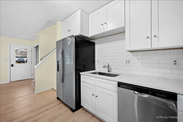 a kitchen with a sink and cabinets