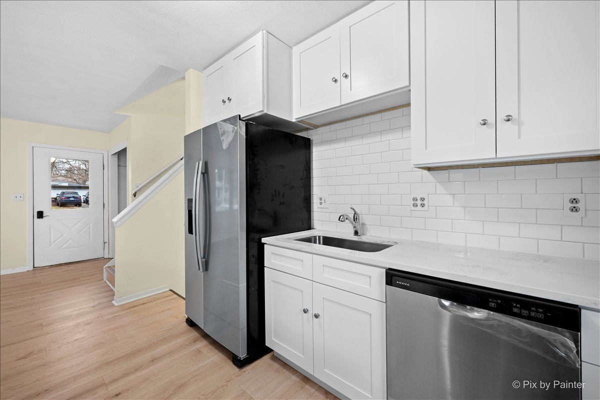 131 Bullard Street Poplar Grove, IL 61065 - Photo 11 of 25 a kitchen with a sink and cabinets
