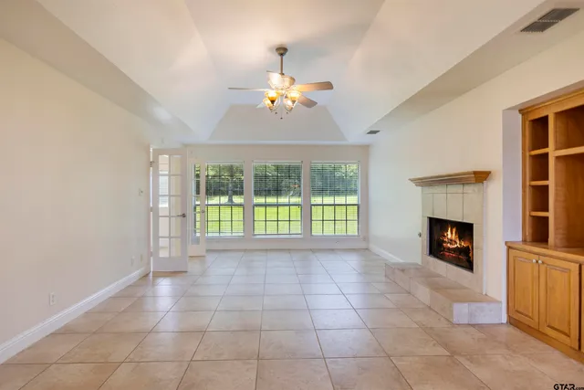 a large kitchen with granite countertop a sink and cabinets