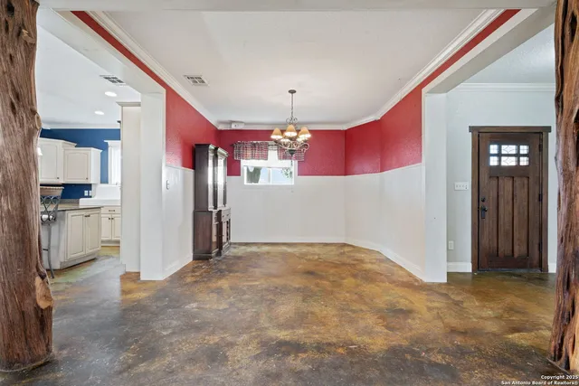 a kitchen with kitchen island granite countertop a sink cabinets and stainless steel appliances
