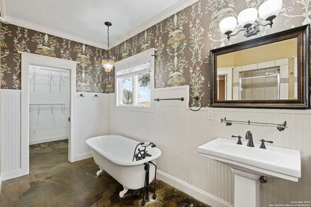 a bathroom with a sink a mirror and shower