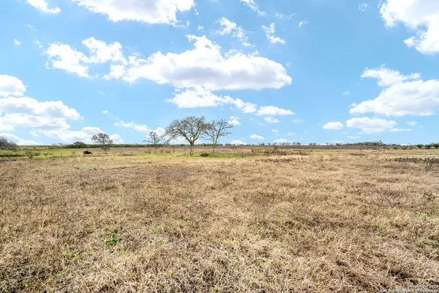 a view of swimming pool with outdoor seating and yard in back
