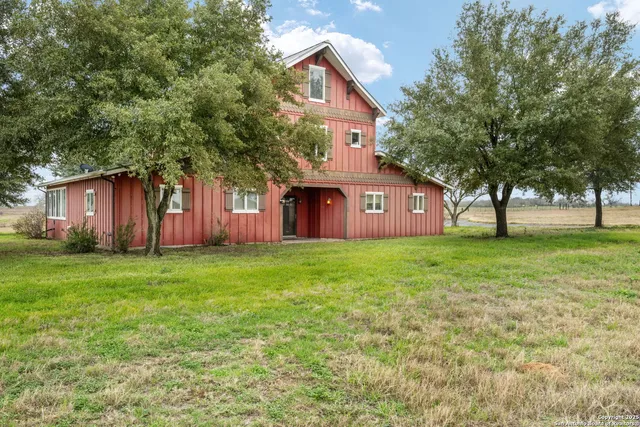 a view of a house with a backyard