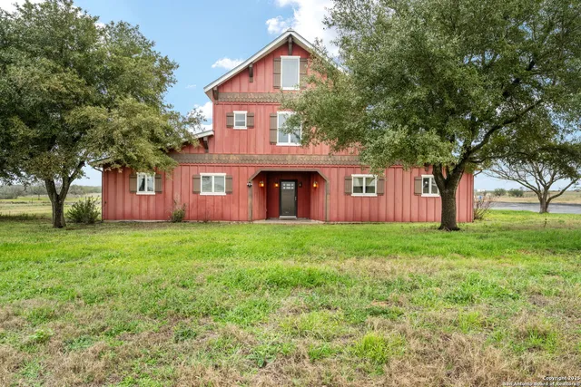 a view of a kitchen with granite countertop wooden cabinets