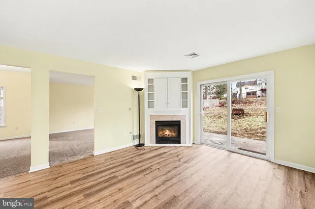 a view of kitchen with refrigerator cabinets and wooden floor