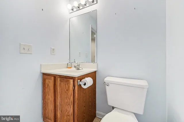 an empty room with fan and entrance